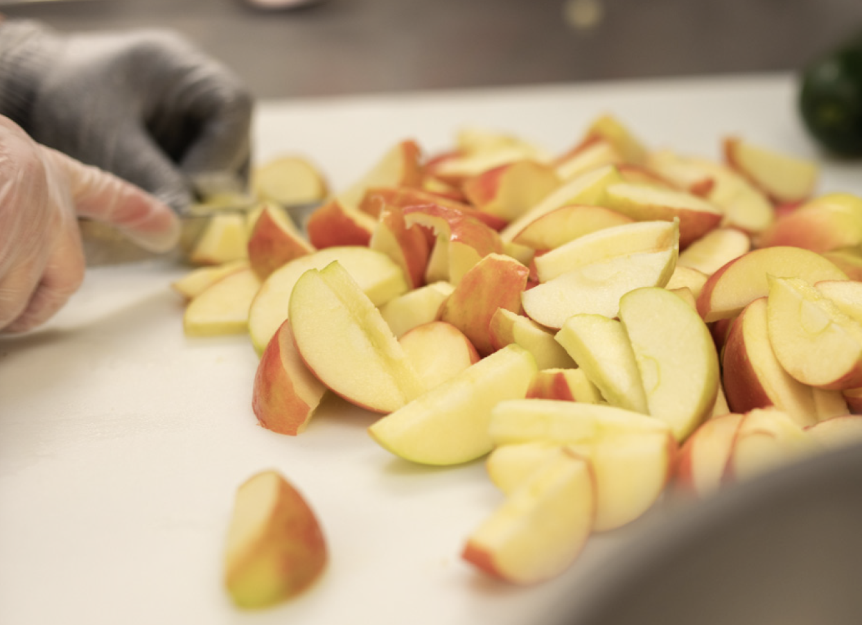A school chef slices up apples.